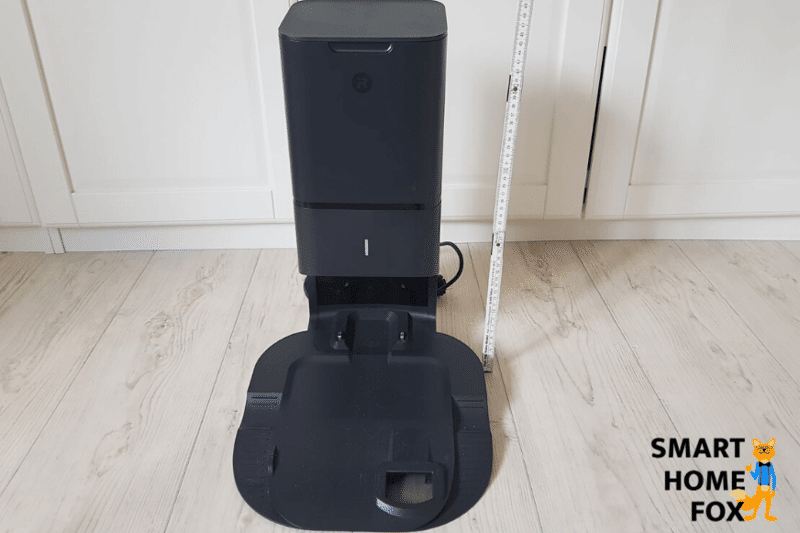 Measuring the Roomba i7+ clean base with ruler